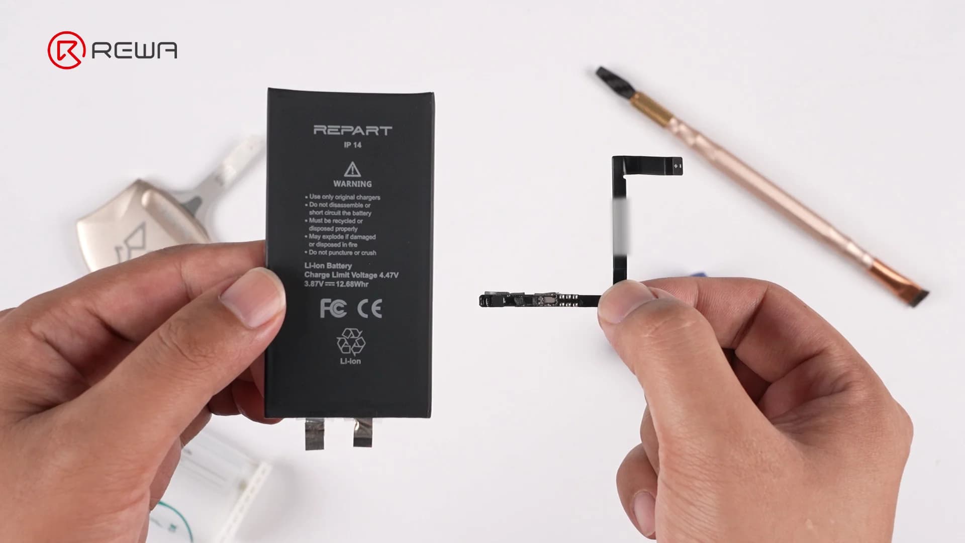 Hands holding a black iPhone 14 battery cell on the left and a small BMS board with flex cable on the right