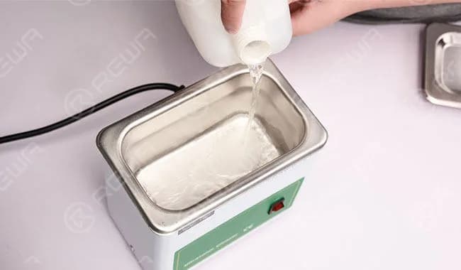 Pour adequate PCB cleaner into the ultrasonic cleaner and put the logic board in. Power on and get the lid on.